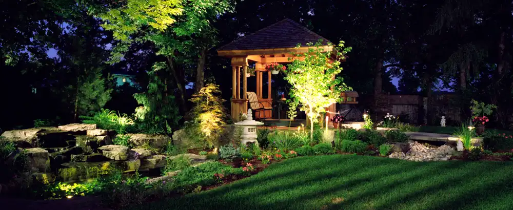 Garden and greenhouse lit at night