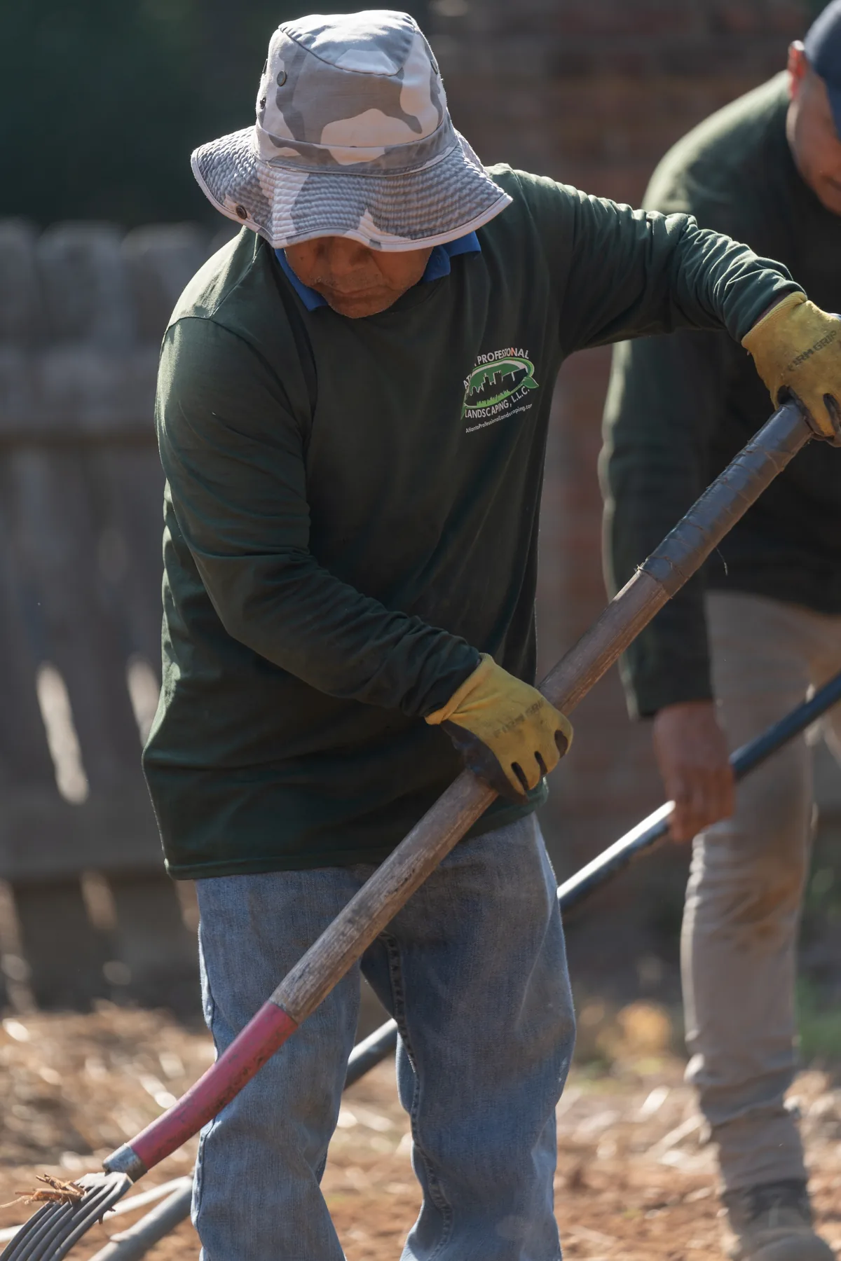 Crew raking and spreading soil