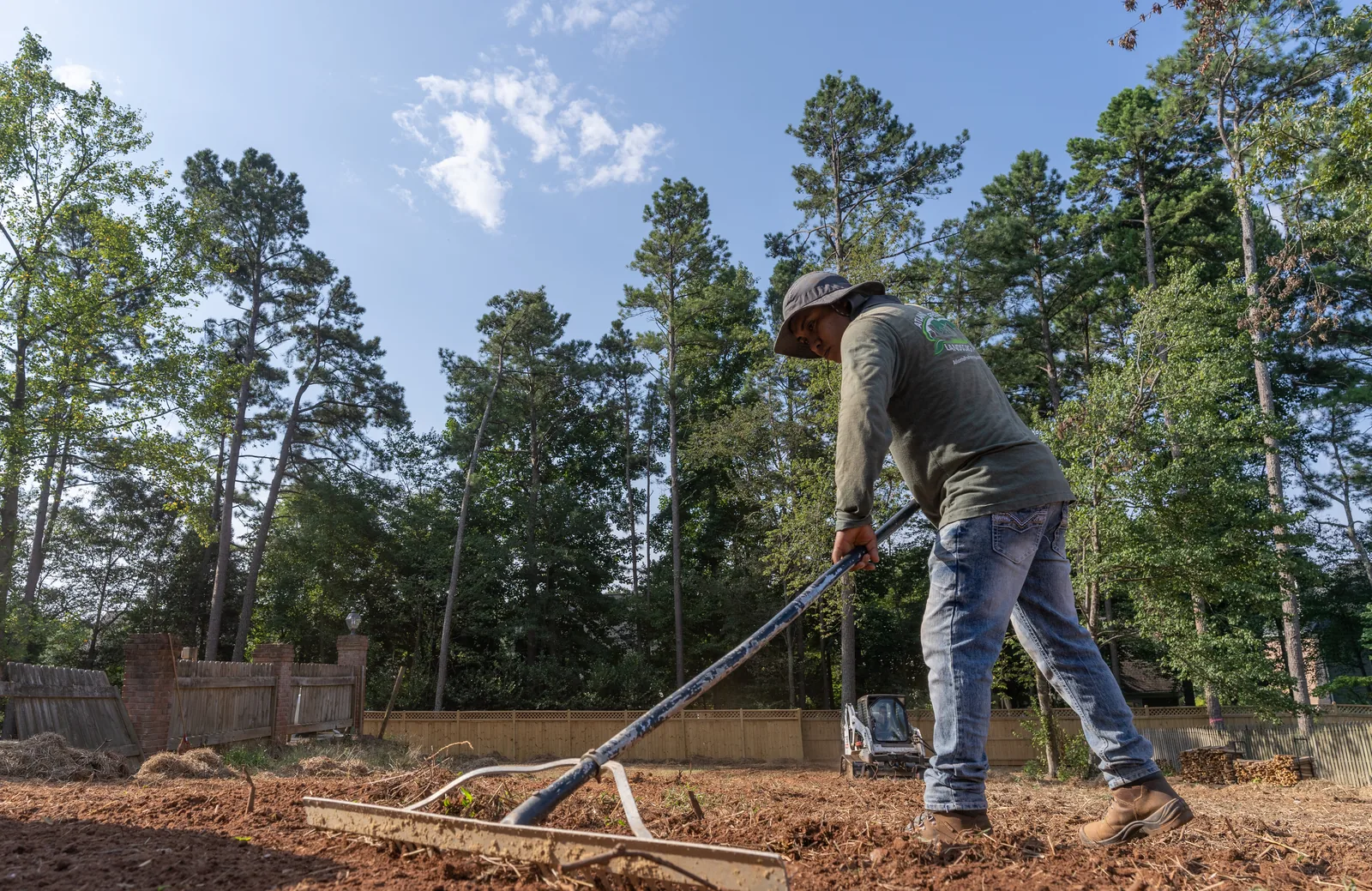 Crew raking graded soil